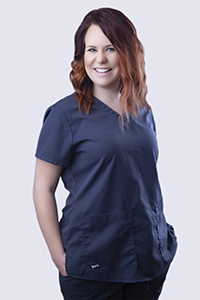 A portrait photo of Stephanie wearing navy blue scrubs